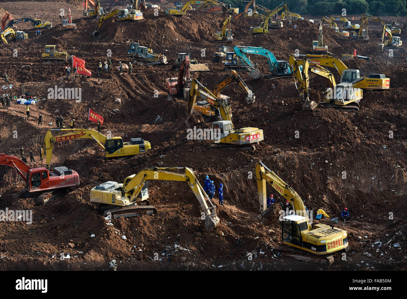 Shenzhen, China's Guangdong Province. 25th Dec, 2015. Rescuers work at the landslide site at an industrial park in Shenzhen, south China's Guangdong Province, Dec. 25, 2015. A landslide that has left dozens missing in Shenzhen was a work safety incident, not a geological disaster, a State Council investigation team confirmed Friday. The tragedy was caused by the collapse of a huge pile of construction waste, rather than any natural geological phenomenon, the investigation team said in a statement. Credit:  Mao Siqian/Xinhua/Alamy Live News Stock Photo