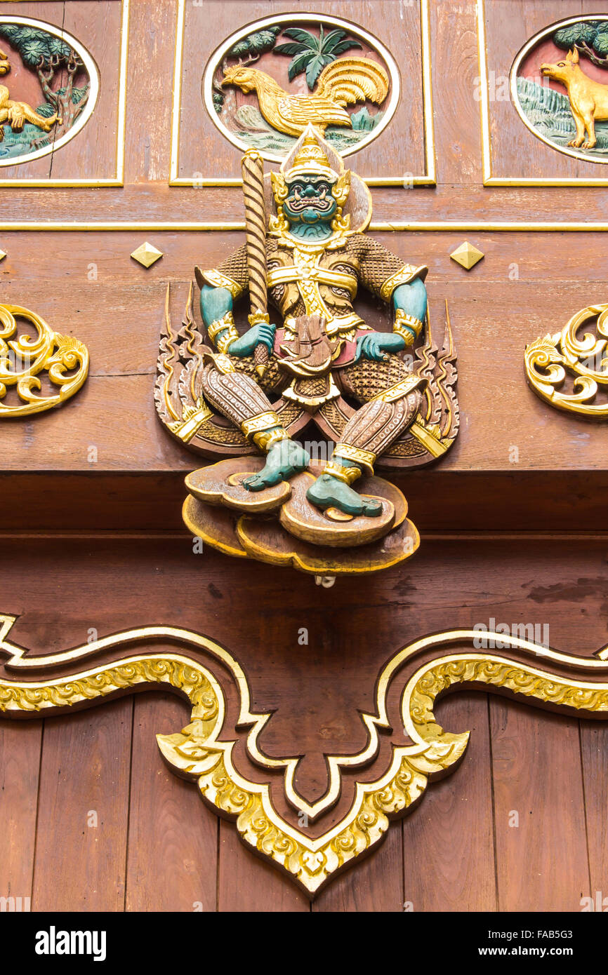 Thai giant Wood Carving on teak chapel Stock Photo