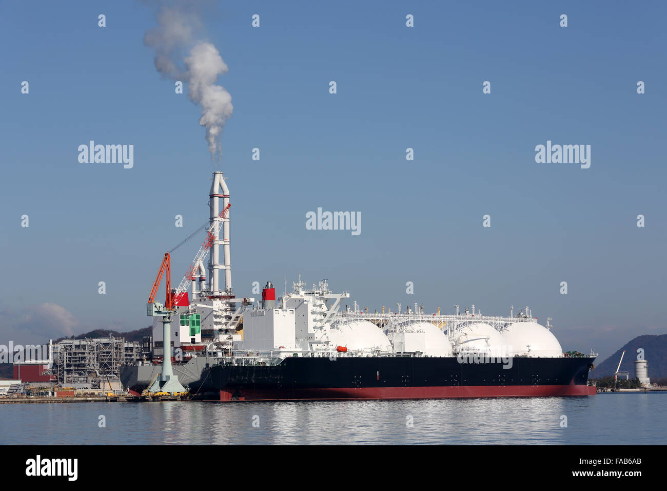 Lng cargo ship docked in the port Stock Photo