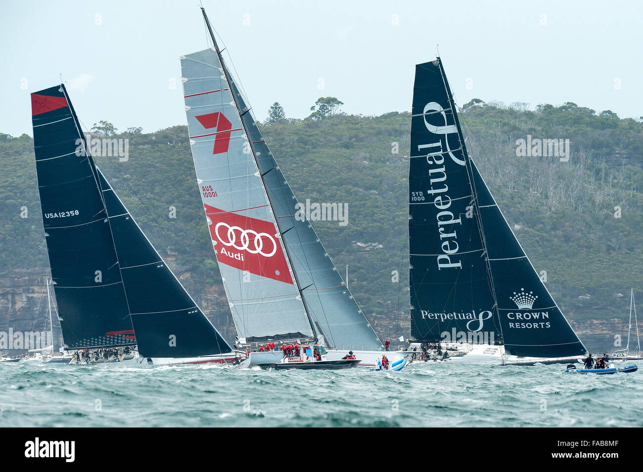 Sydney, Australia. 26th Dec, 2015. Rolex Sydney to Hobart Yacht race 2015. Wild Oats XI owned by Robert Oatley from NSW skippered by Mark Richards type RP100, Perpetual Loyal owner/skipper by Anthony Bell from NSW type Juan-K 100. and Comanche owned by Jim Clark &amp; Kristy Hinze Clark from SA skippered by Ken Read type 100 Supermaxi lead the race through the Heads during the start of the 629 nautical mile race from Sydney to Hobart on Sydney Harbour. Credit:  Action Plus Sports/Alamy Live News Stock Photo
