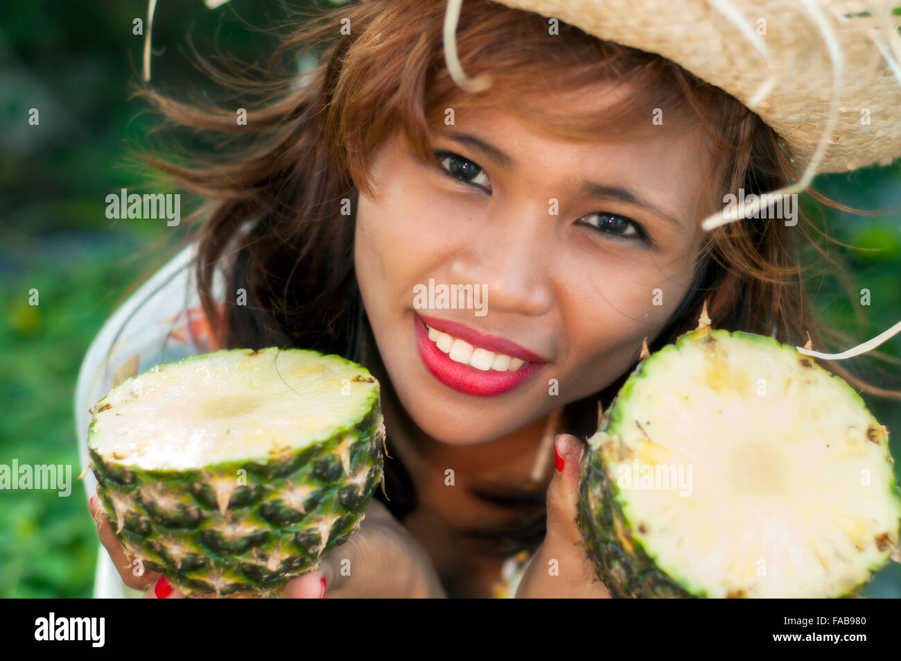 Young Asian woman with pineapple, on location, Cebu, Philippines Stock Photo
