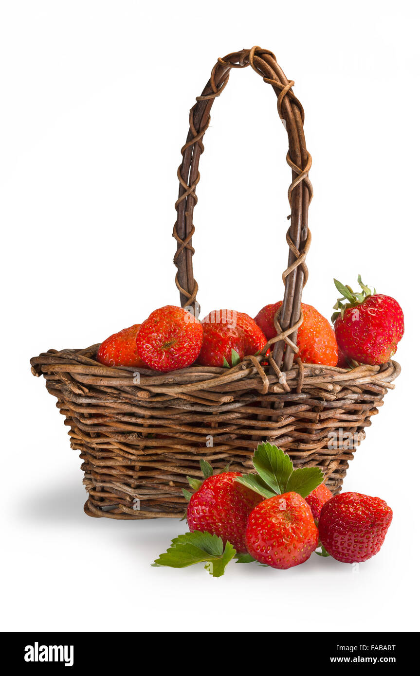 Delicious red summer strawberries in a brown rush basket. Stock Photo