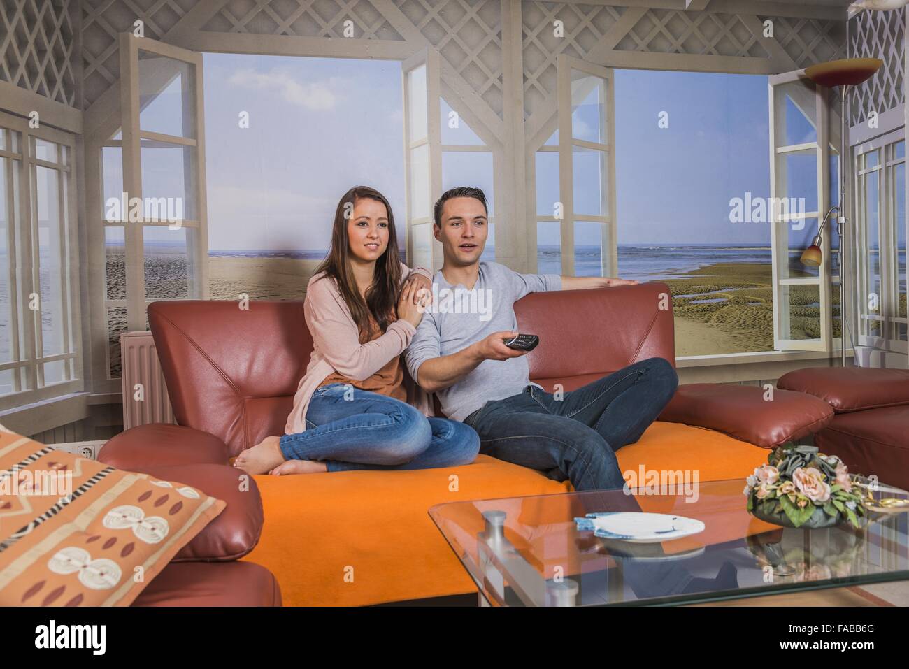 Female sitting on couch in hi-res stock photography and images - Alamy