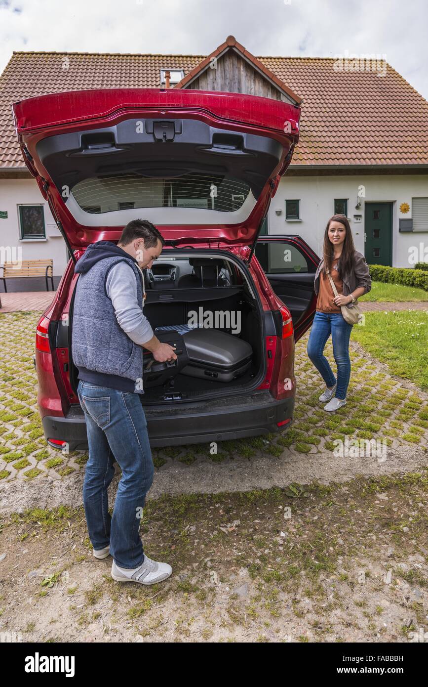Woman suitcases car hi-res stock photography and images - Alamy