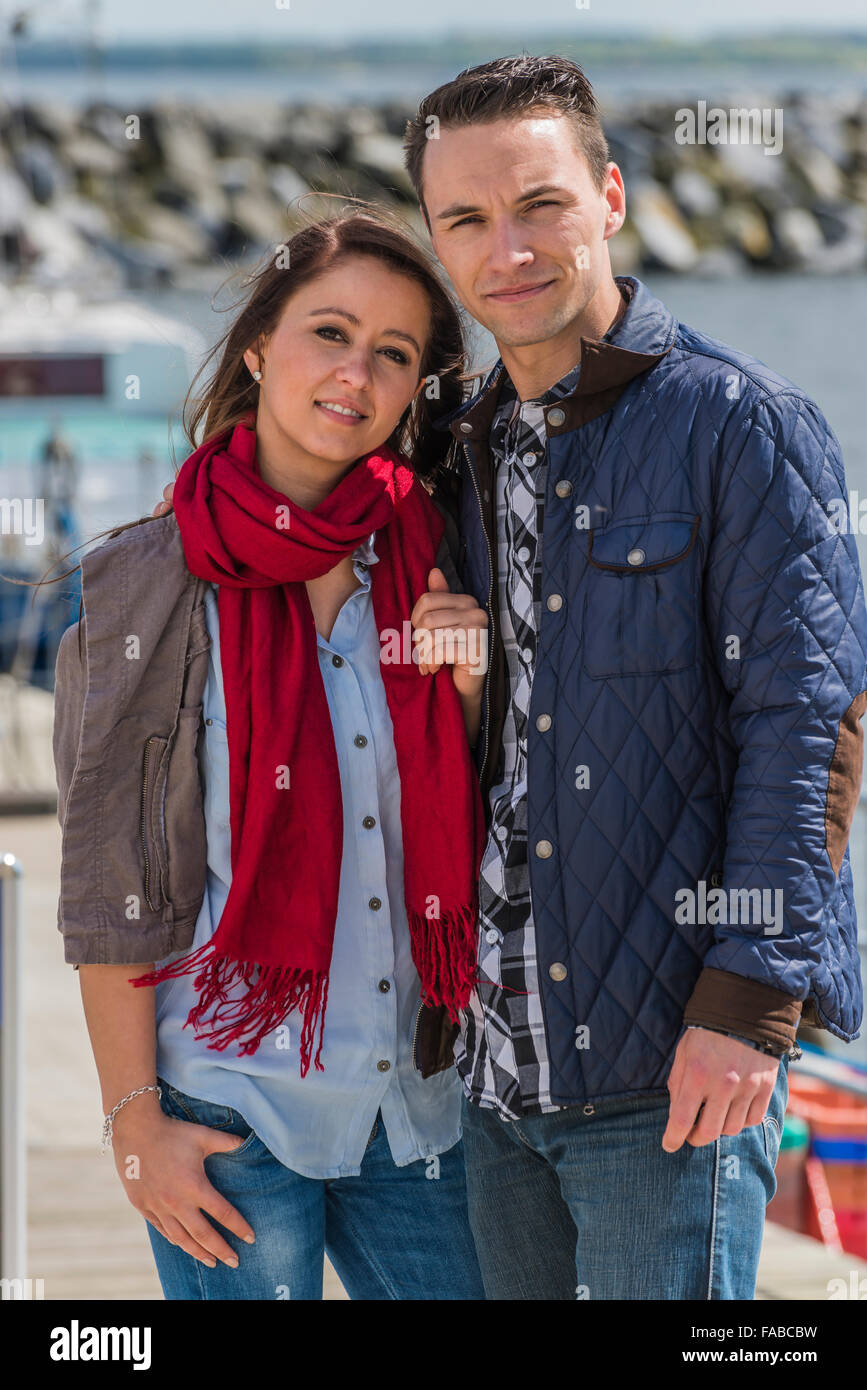 Couple 25-30 age standing in a harbor at the Baltic sea Stock Photo