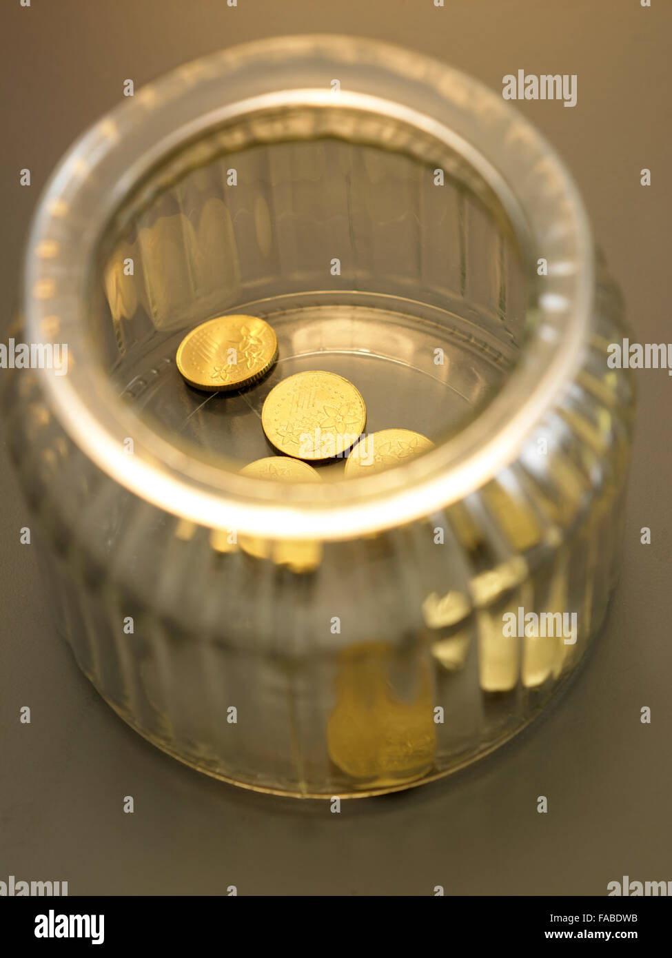 few pieces of coin in the saving jar Stock Photo