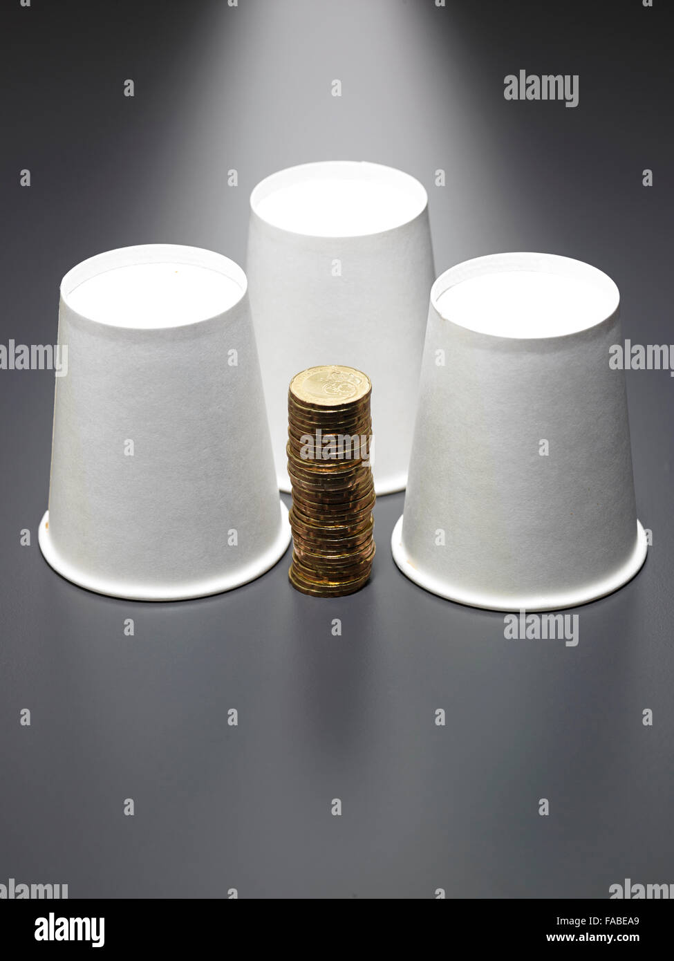 stack of gold coin in front of paper cup Stock Photo