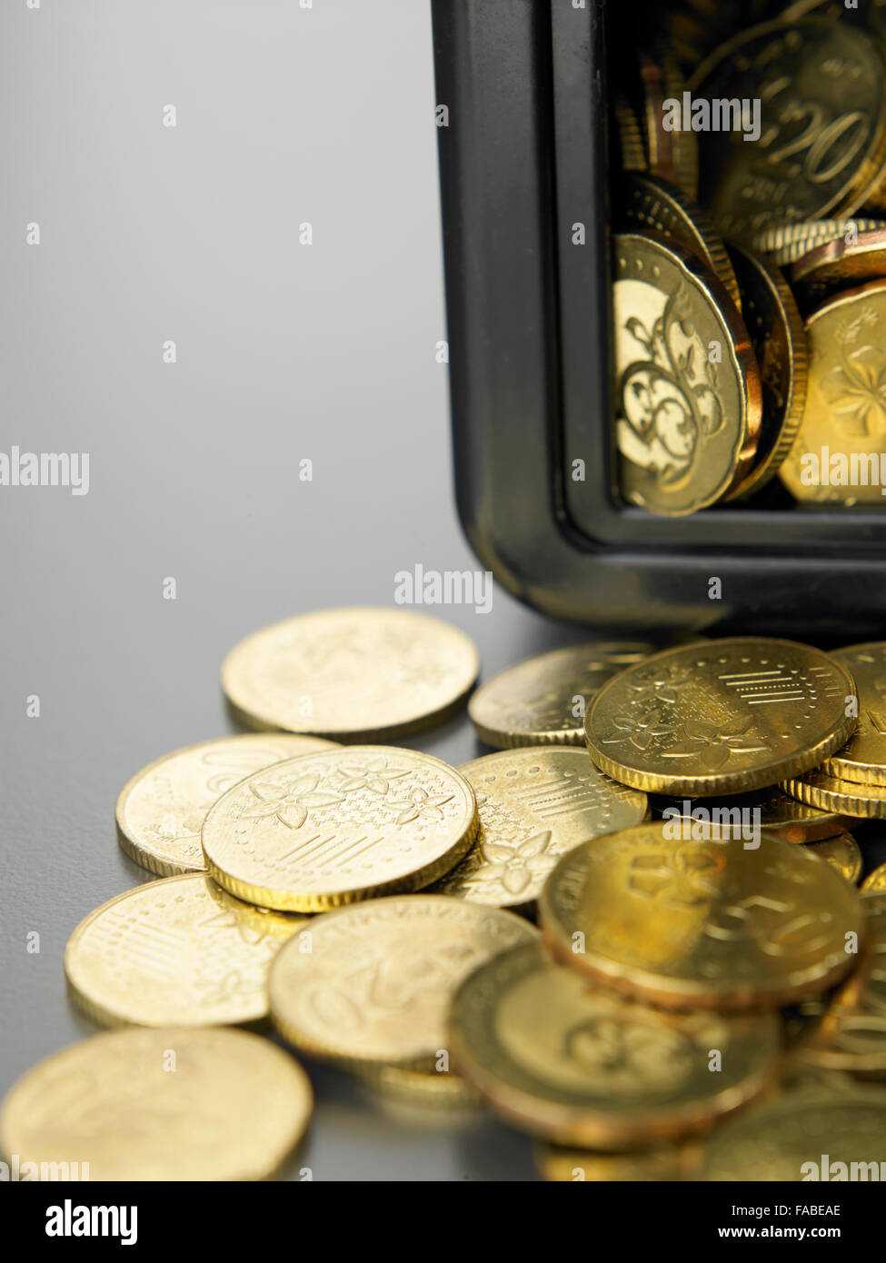 coins in front of the mini safe box Stock Photo