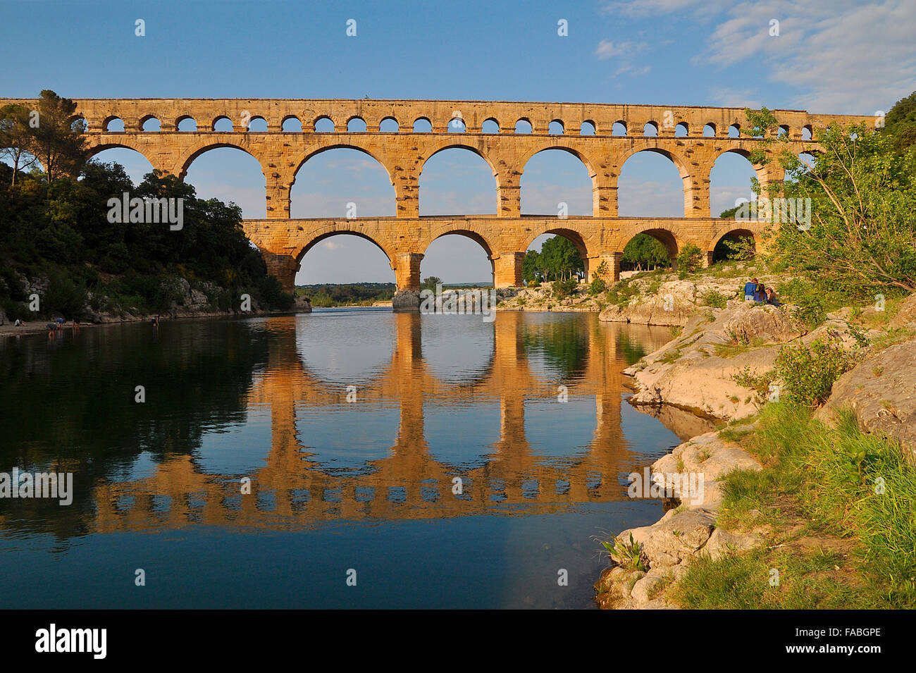 Roman aqueduct Pont du Gard reflected in the Gardon river, Remoulins, Provence, Southern France, France, Europe Stock Photo