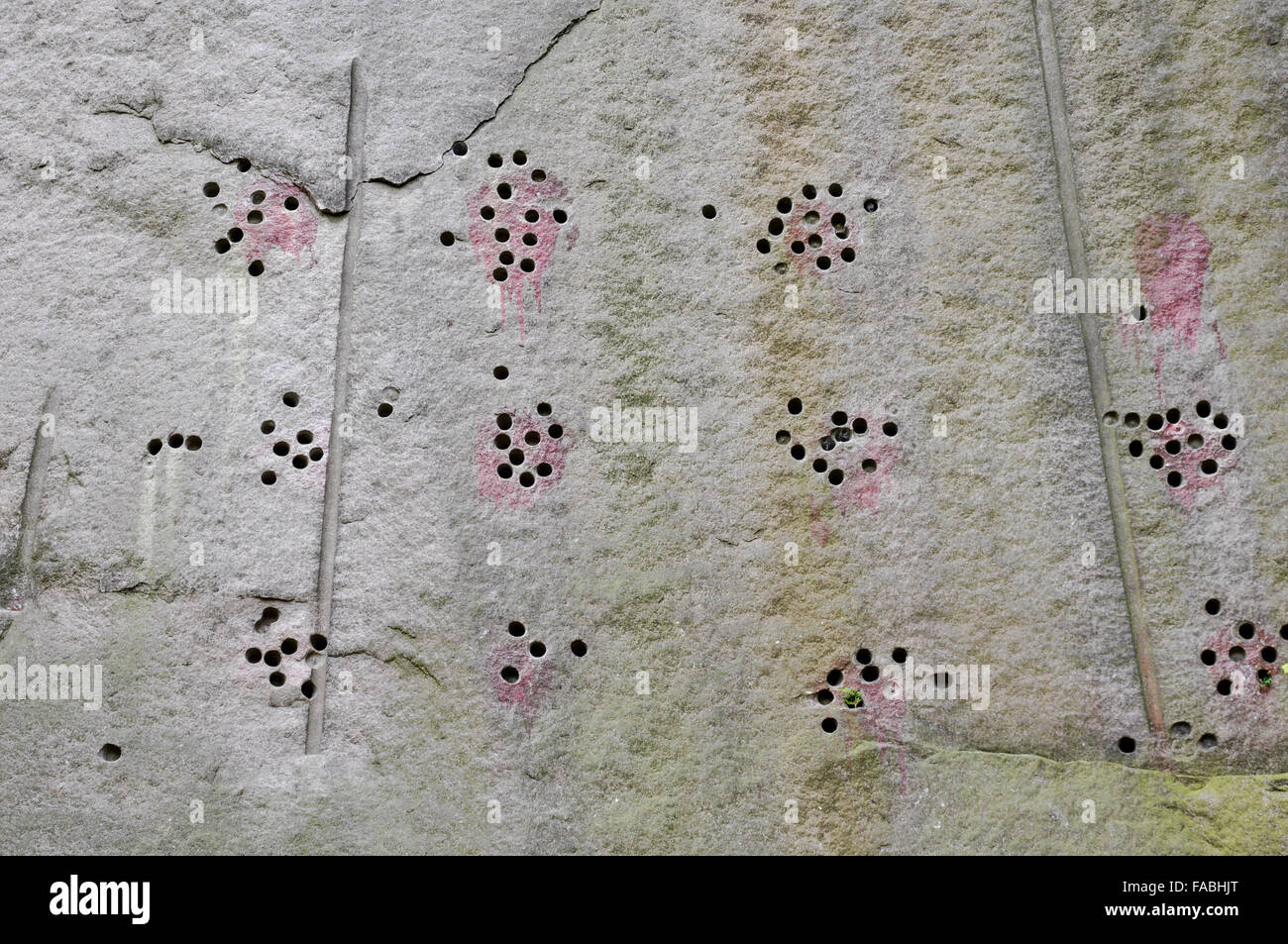 Markings left in the cliff face of the quarry at  Millstone edge in the Peak District, Derbyshire. Stock Photo