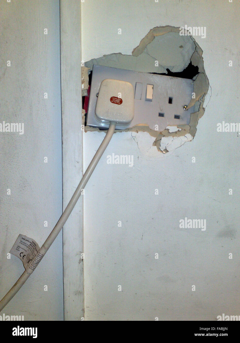 Kicked in electric wall socket Stock Photo Alamy