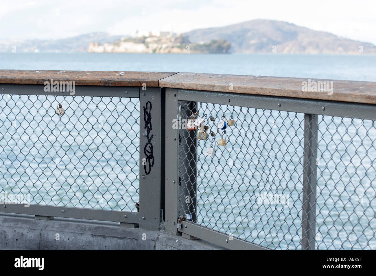 Lovers' padlocks on railing fence on Fisherman's Wharf overlooking