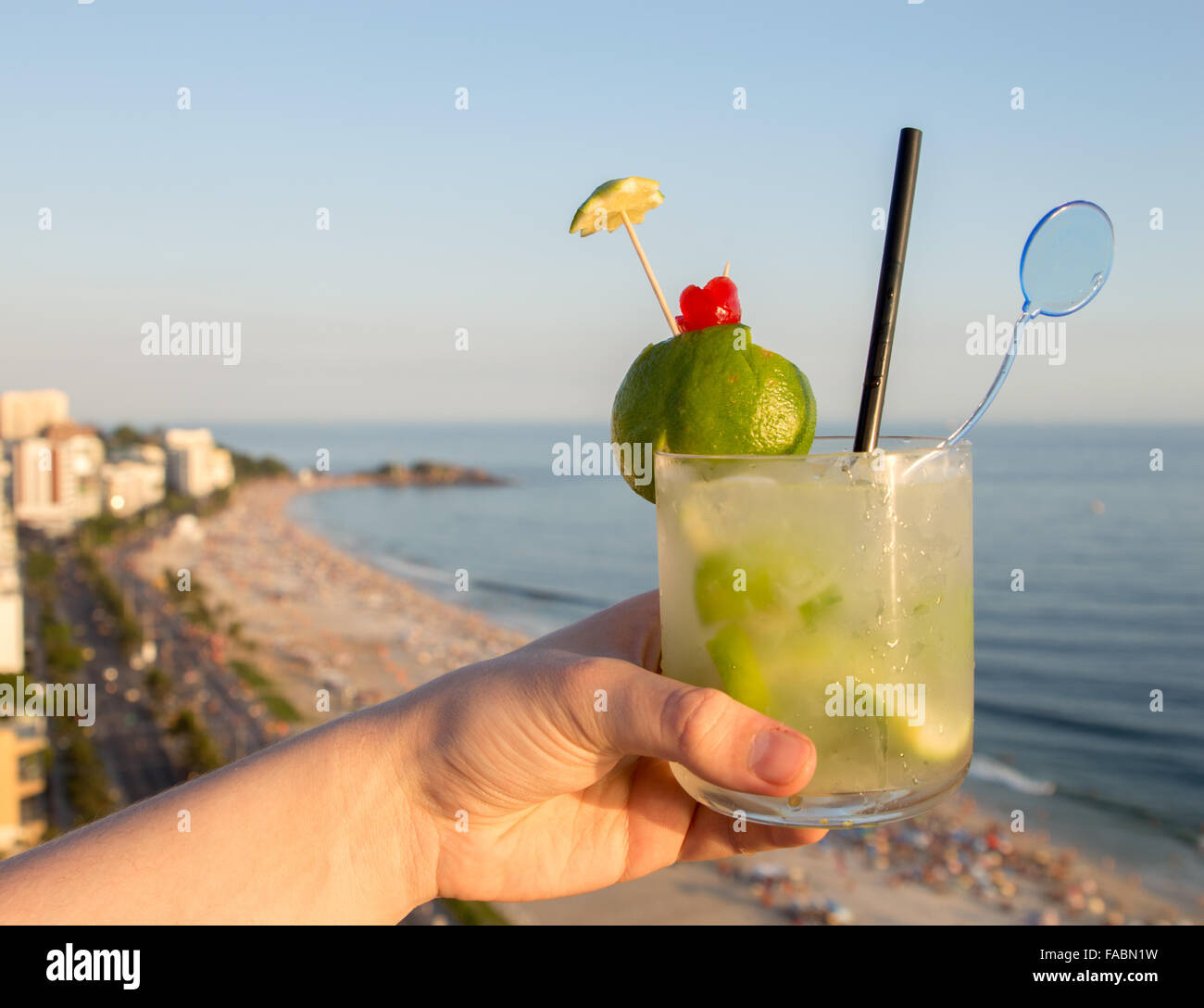 A delicious kiwi caipirinha drink overlooking the iconic Ipanema beach in Rio de Janeiro, Brazil Stock Photo