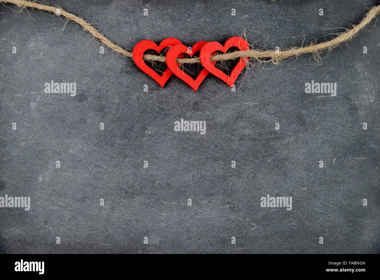 Vintage chalkboard with three red heart shape symbols on rope, retro ...