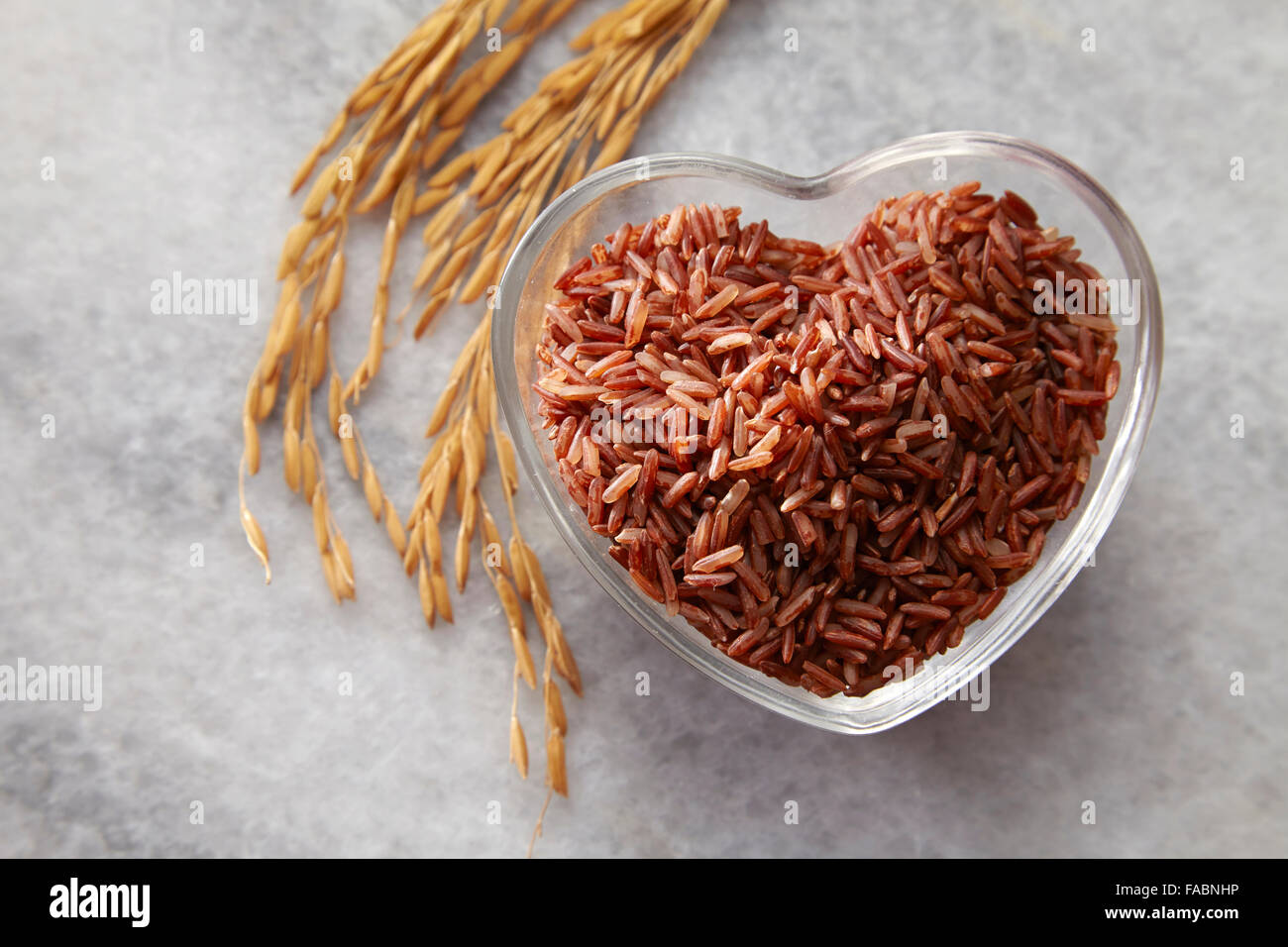 brown rice in a heart shape cointainer Stock Photo - Alamy