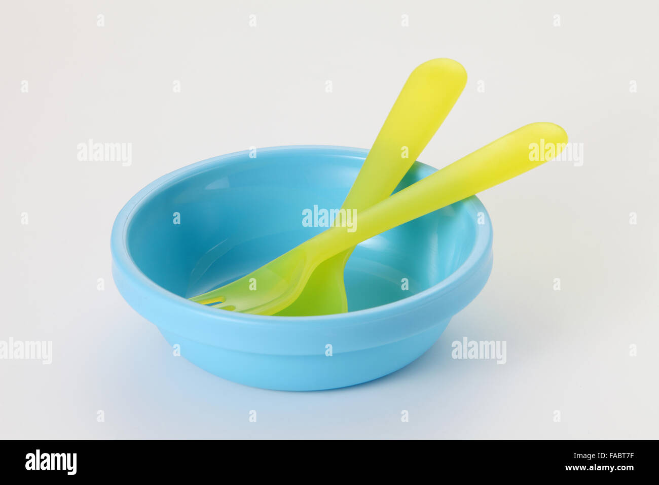 blue plastic bowl and yellow cutlery set Stock Photo Alamy