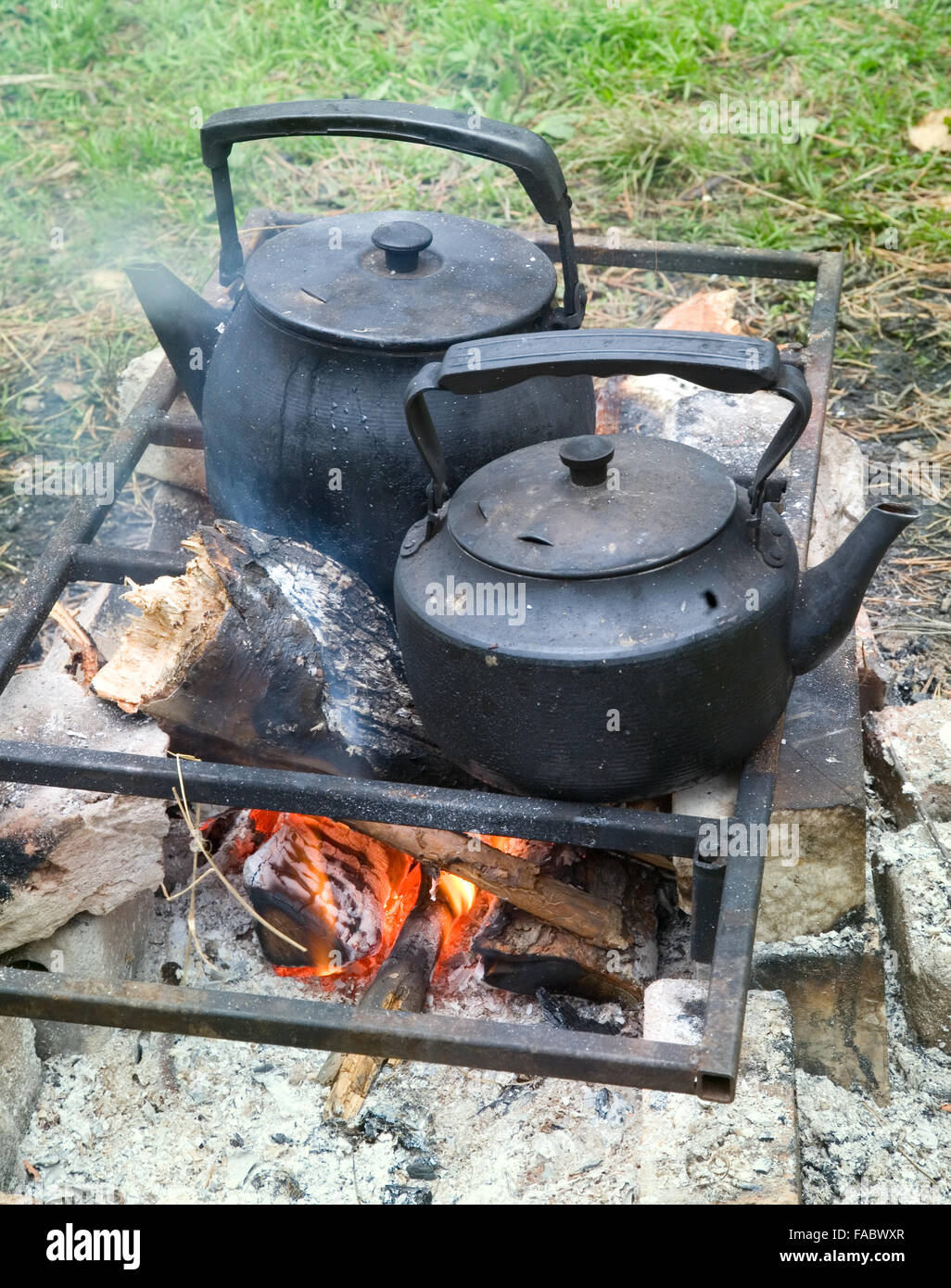 Two black kettle over an open fire Stock Photo - Alamy