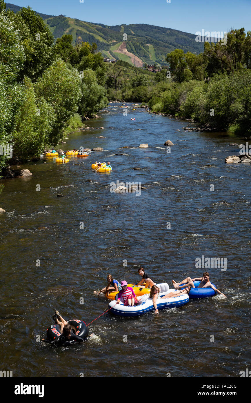 People raft using tubes down the Yampa River on a summer day in ...