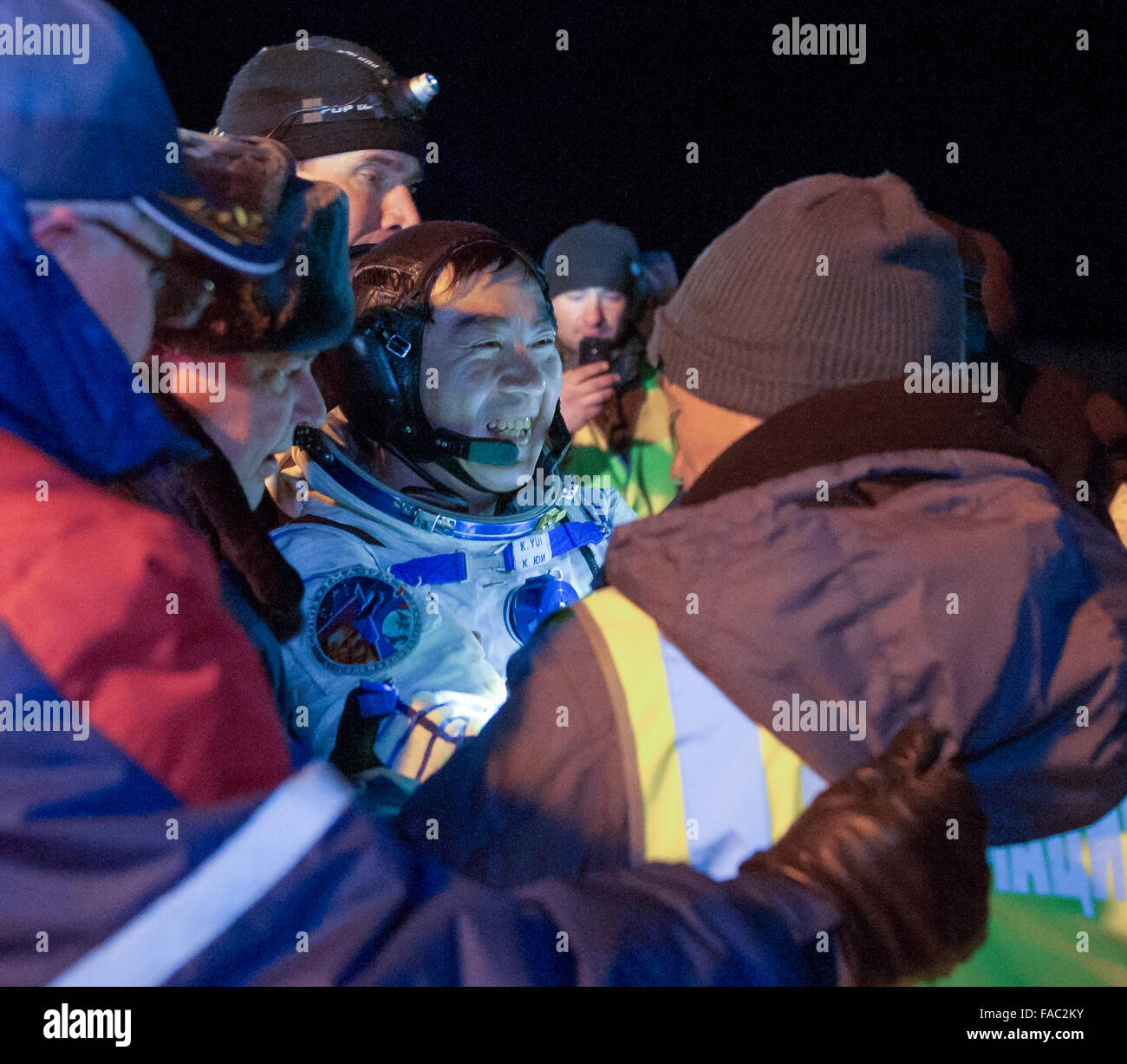 International Space Station Expedition 45 crew member Japanese astronaut Kimya Yui of the Japan Aerospace Exploration Agency is carried to the medical tent moments after landing in a remote area in the Soyuz TMA-17M spacecraft December 11, 2015 near Zhezkazgan, Kazakhstan. The crew is returning after 141 days onboard the International Space Station. Stock Photo