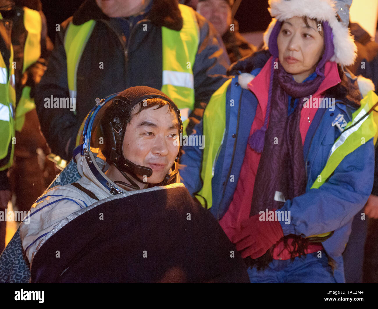 International Space Station Expedition 45 crew member Japanese astronaut Kimya Yui of the Japan Aerospace Exploration Agency is carried to the medical tent moments after landing in a remote area in the Soyuz TMA-17M spacecraft December 11, 2015 near Zhezkazgan, Kazakhstan. The crew is returning after 141 days onboard the International Space Station. Stock Photo