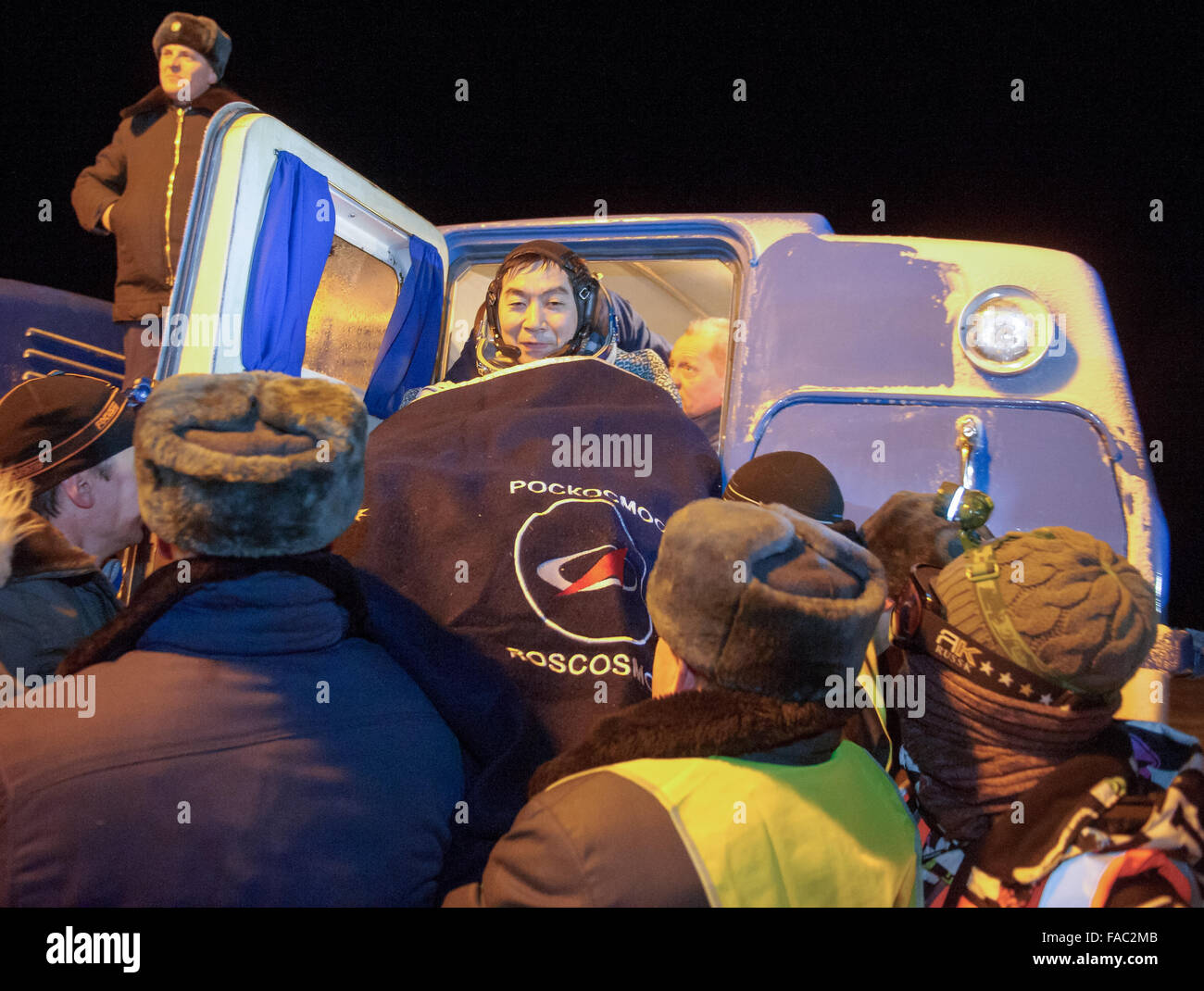 International Space Station Expedition 45 crew member Japanese astronaut Kimya Yui of the Japan Aerospace Exploration Agency is loaded on the All Terrain Recovery Vehicle moments after landing in a remote area in the Soyuz TMA-17M spacecraft December 11, 2015 near Zhezkazgan, Kazakhstan. The crew is returning after 141 days onboard the International Space Station. Stock Photo