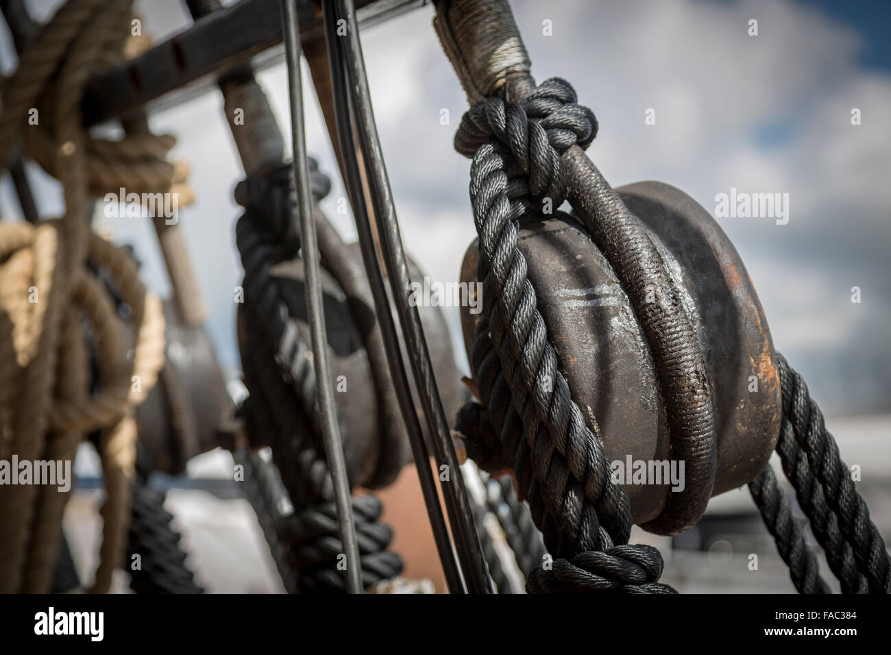 Wooden pulley blocks on reproduction tall ship Stock Photo