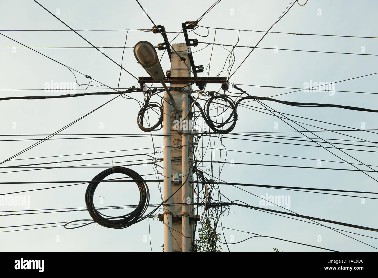 tangle of electrical wires on a pole Stock Photo