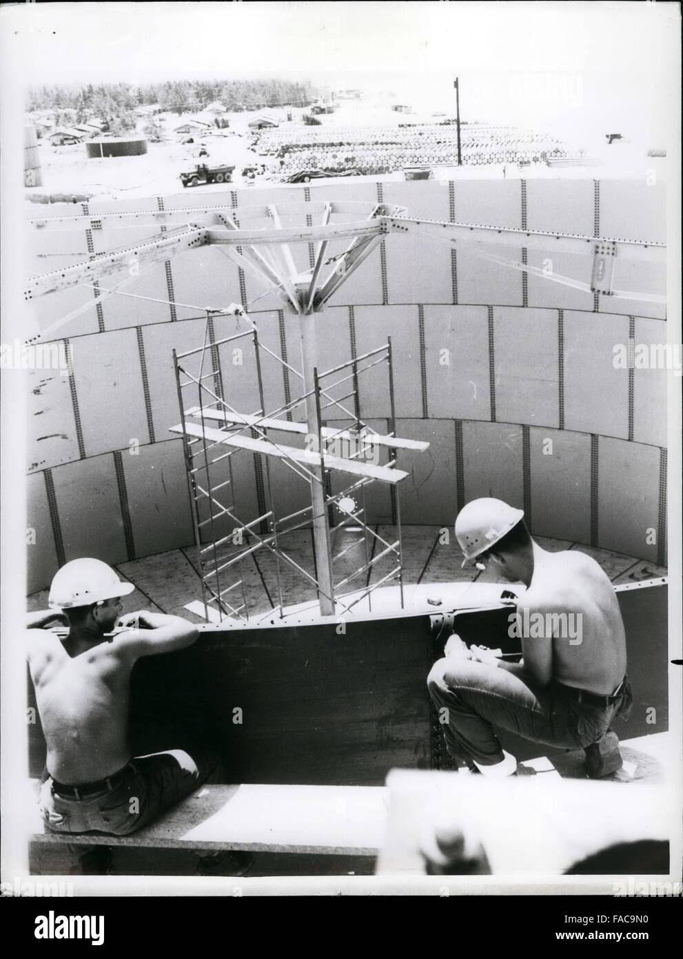 1968 - Over The Top - Navy Seabee steel workers of Naval Mobile Construction Battalion Seventy One tighten the last few bolts on the top of one of the five aviation jet fuel storage tanks being built at Chu Lai, South Vietnam. The mast rising put of the center of the circular tank will support the tank's lid. © Keystone Pictures USA/ZUMAPRESS.com/Alamy Live News Stock Photo