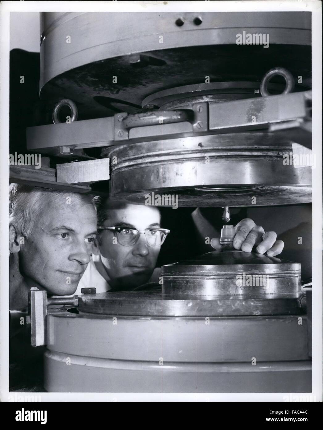 1972 - Big Squeeze: High pressure-high temperature equipment is used by scientists at the General Electric Research and Development Center, Schenectady, N.Y., to compress thousands of tiny crystals of Man-MadeÃ¢''ž¢ diamond or BorazonÃ¢''ž¢ cubic boron nitride into two new families of cutting tools. Designed to machine the world's toughest materials at high speeds and low wear, the tools promise dramatic increases in cutting speeds, tool life, and overall productivity. Dr. Robert H. Wentorf, Jr. (left) and William A. Rocco prepare one of the giant presses used to convert the Man-Made diamond o Stock Photo