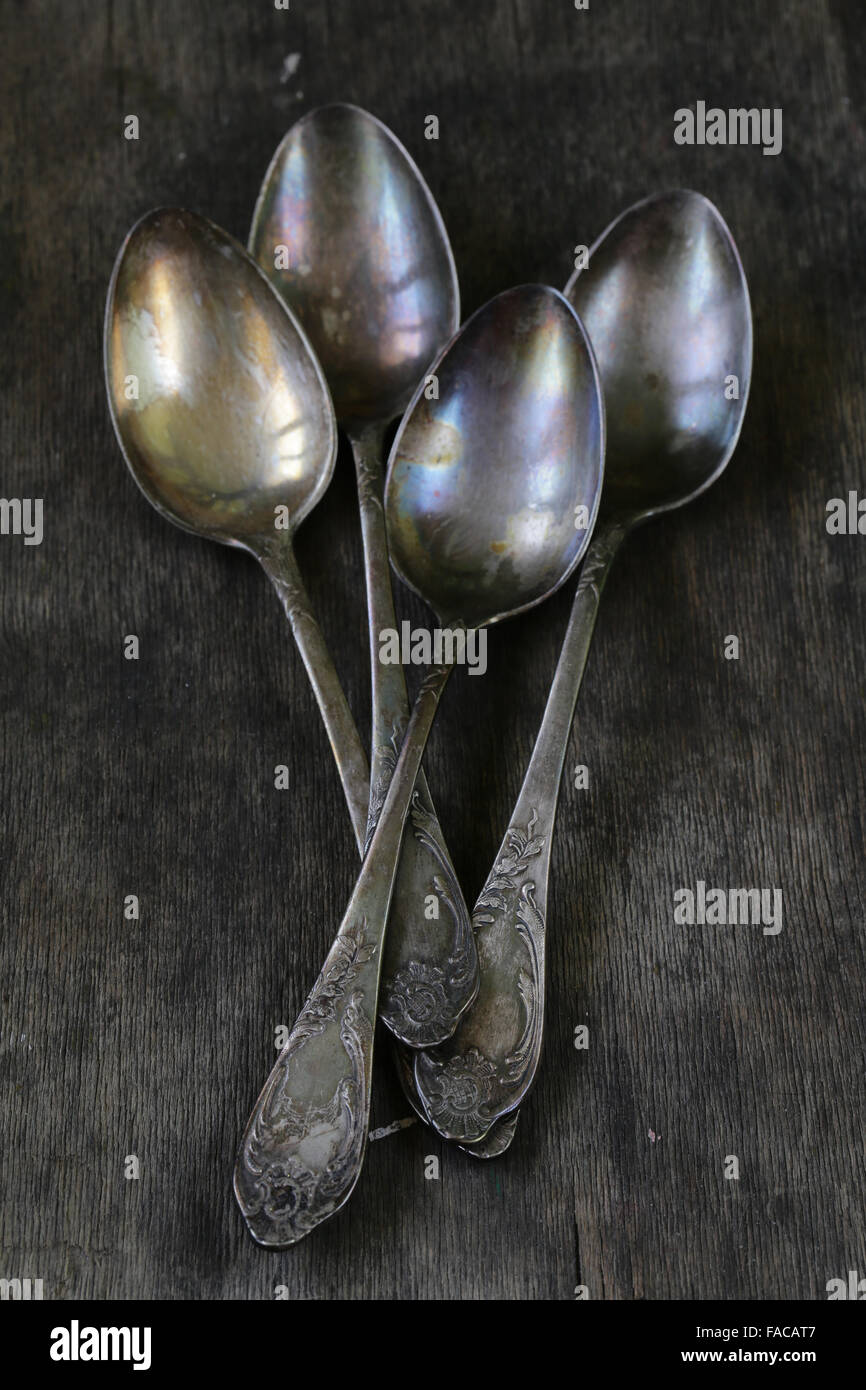 vintage silver spoons on a wooden background Stock Photo