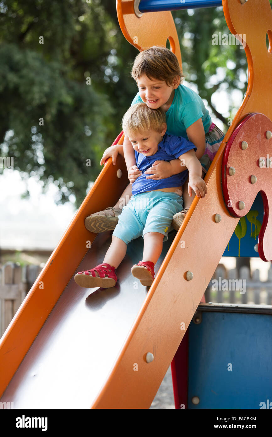 girls on slide at playground area in summer Stock Photo - Alamy
