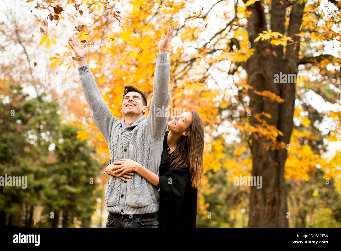 Young couple in the autumn park Stock Photo - Alamy