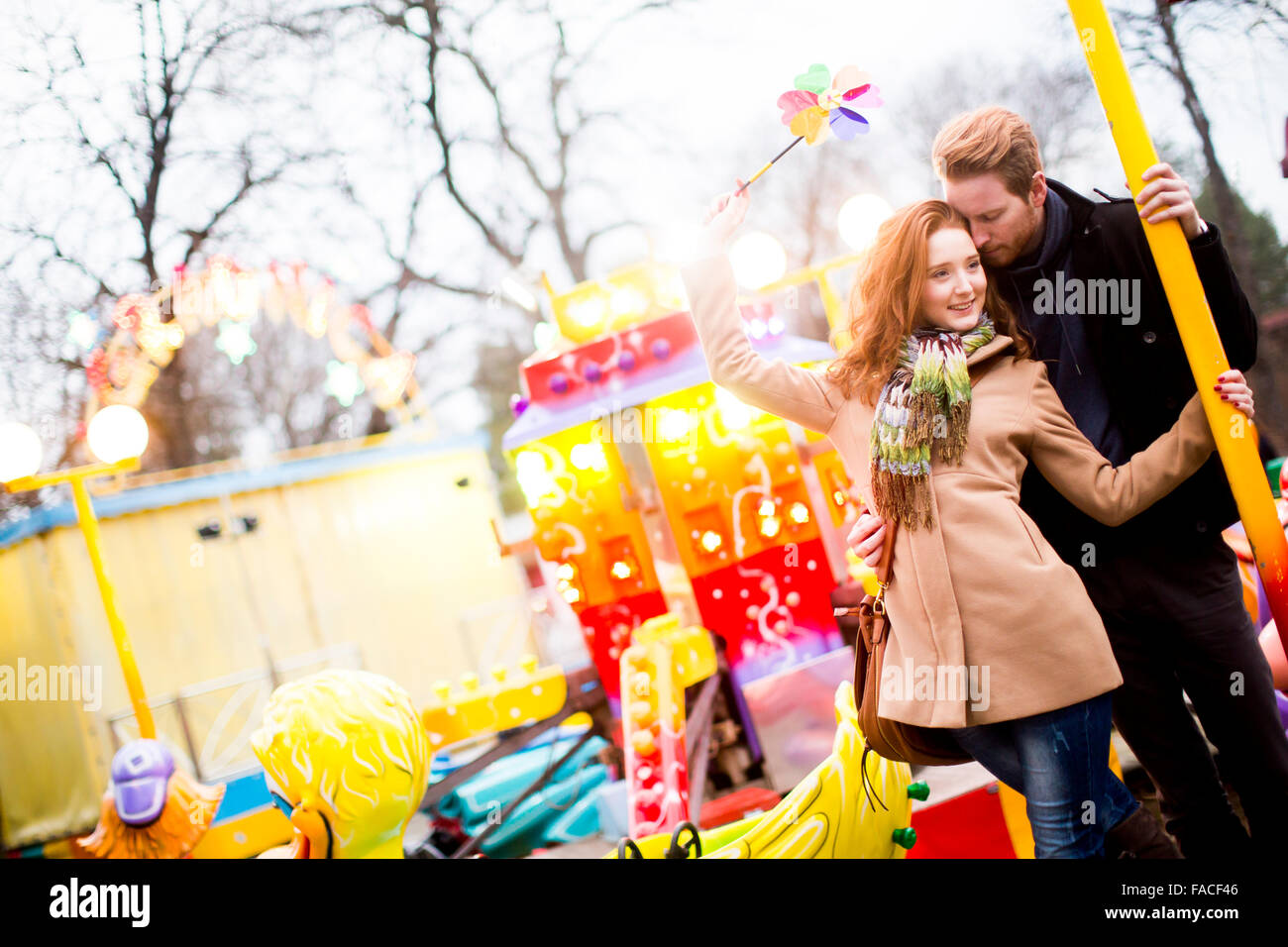 Young couple in the amusement park Stock Photo - Alamy