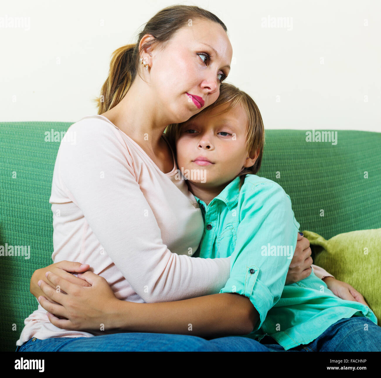 Middle Aged Mother Consoling Sad Teenager At Home Stock Photo