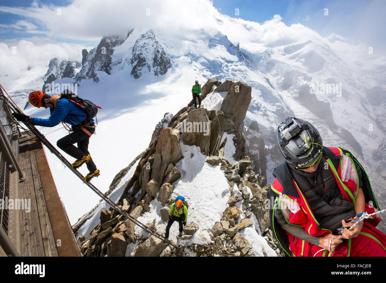 Mont Blanc from the Aiguille Du Midi above Chamonix, France, with climbers on the Cosmiques Arete, climbing the ladder to access Stock Photo