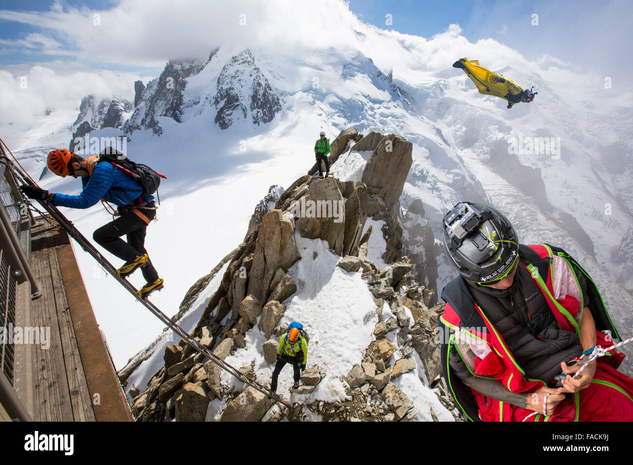 Mont Blanc from the Aiguille Du Midi above Chamonix, France, with climbers on the Cosmiques Arete, climbing the ladder to access Stock Photo