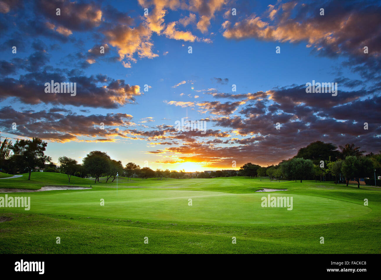 Sunset over golf course with stunning cloud formation and colors Stock