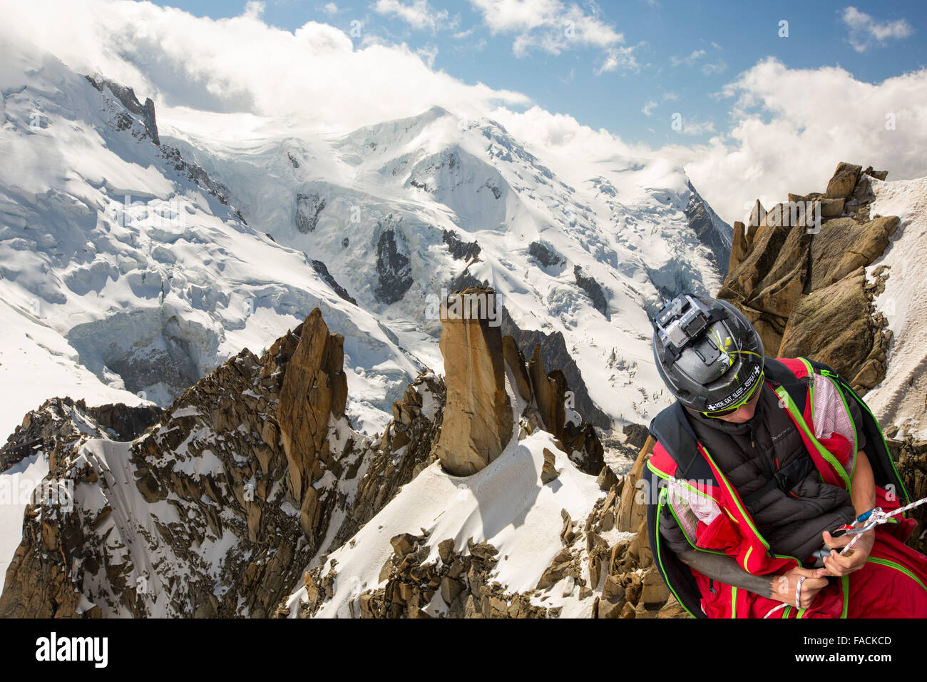 The Cosmiques Aret leading onto the Aiguille Du Midi above Chamonix, France and a base jumper abseiling. Stock Photo