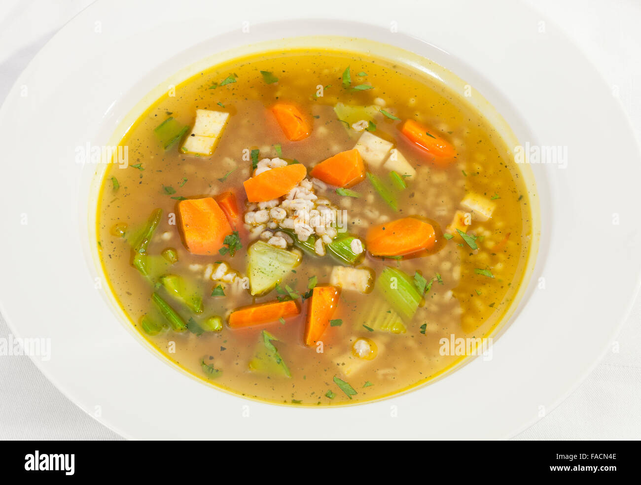 Vegetable soup w carrot, leek and celery stalks Stock Photo
