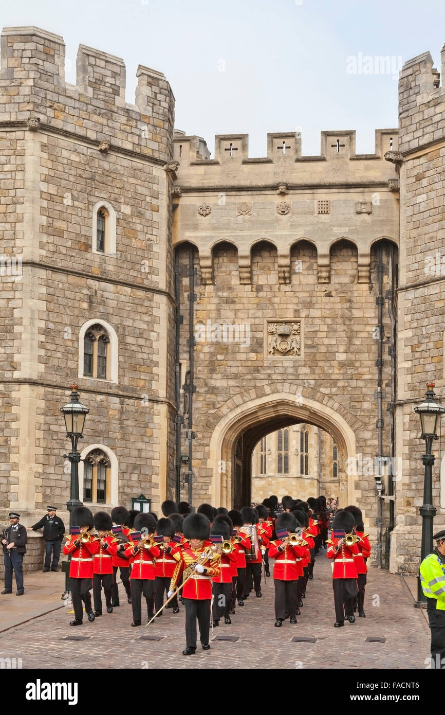 Changing the Guard - a military band emerge from the Henry VIII Gate at Windsor Castle, Berkshire, England, UK Stock Photo