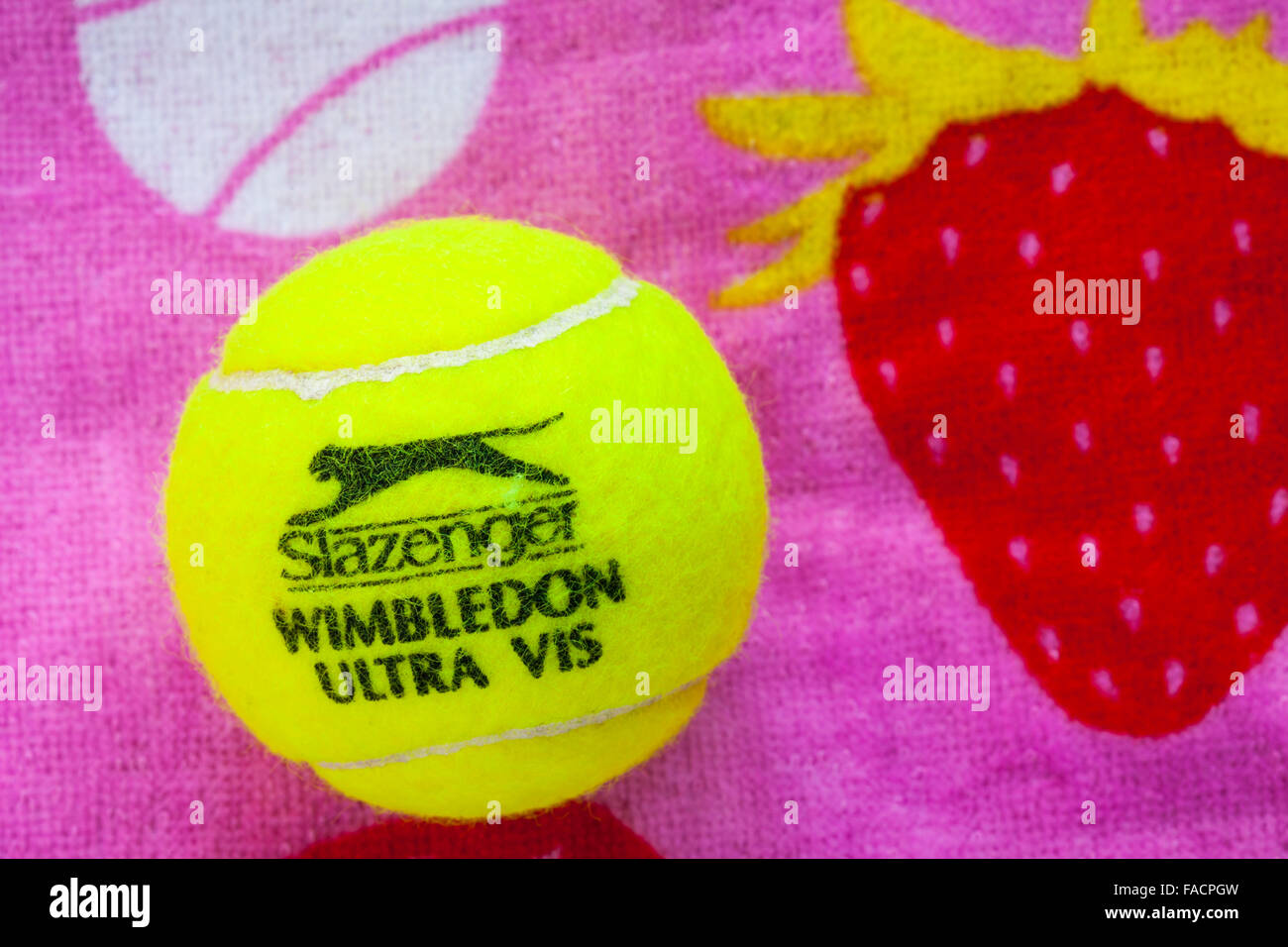 Slazenger Wimbledon tennis ball on Wimbledon tennis towel Stock Photo