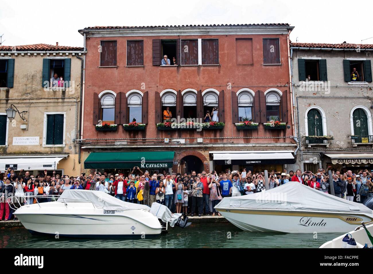 Crowds of onlookers gather to get a glimpse of the U.S First Lady Michelle Obama during her visit June 20, 2015 in Venice, Italy. Stock Photo