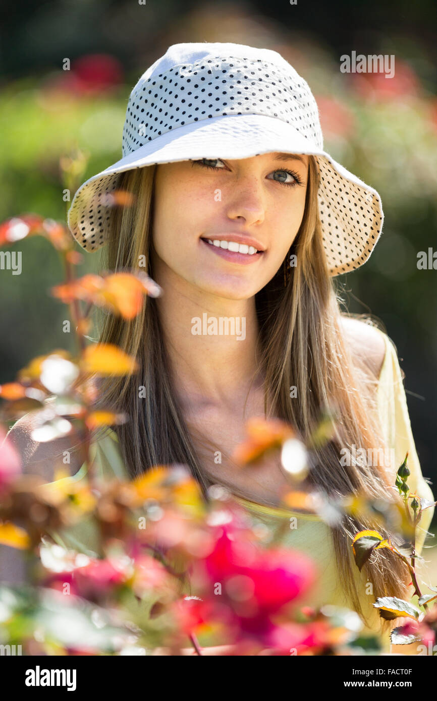 Portrait of a beautiful girl in the garden with flowering plants Stock ...