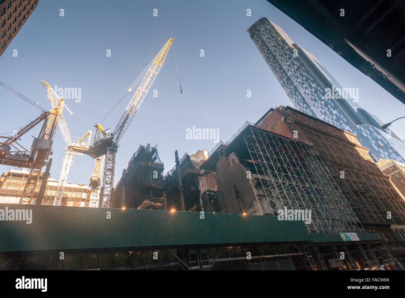 The prestigious Art Students League's French Renaissance style landmark building, right, on West 57th Street in New York is seen shrouded in scaffolding on Sunday, December 20, 2015 for construction of the Extell development which will cantilever 290 feet over the league. The League received $38.1 million in compensation for their air rights. The new skyscraper will be luxury condos and a Nordstrom department store. The One57 billionaire's tower is on the far right. (© Richard B. Levine) Stock Photo