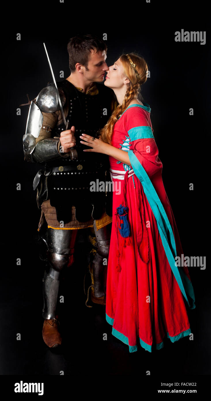 Studio shot of young couple dressed as Medieval knight and maiden