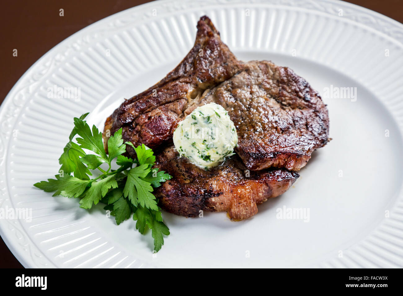 Juicy veal rib steak with green oil Stock Photo
