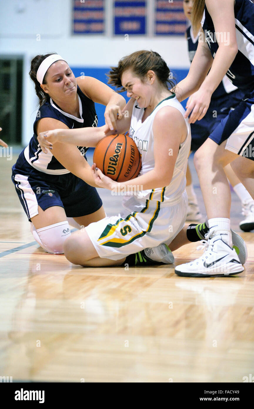During a high school basketball game, players battle for possession of
