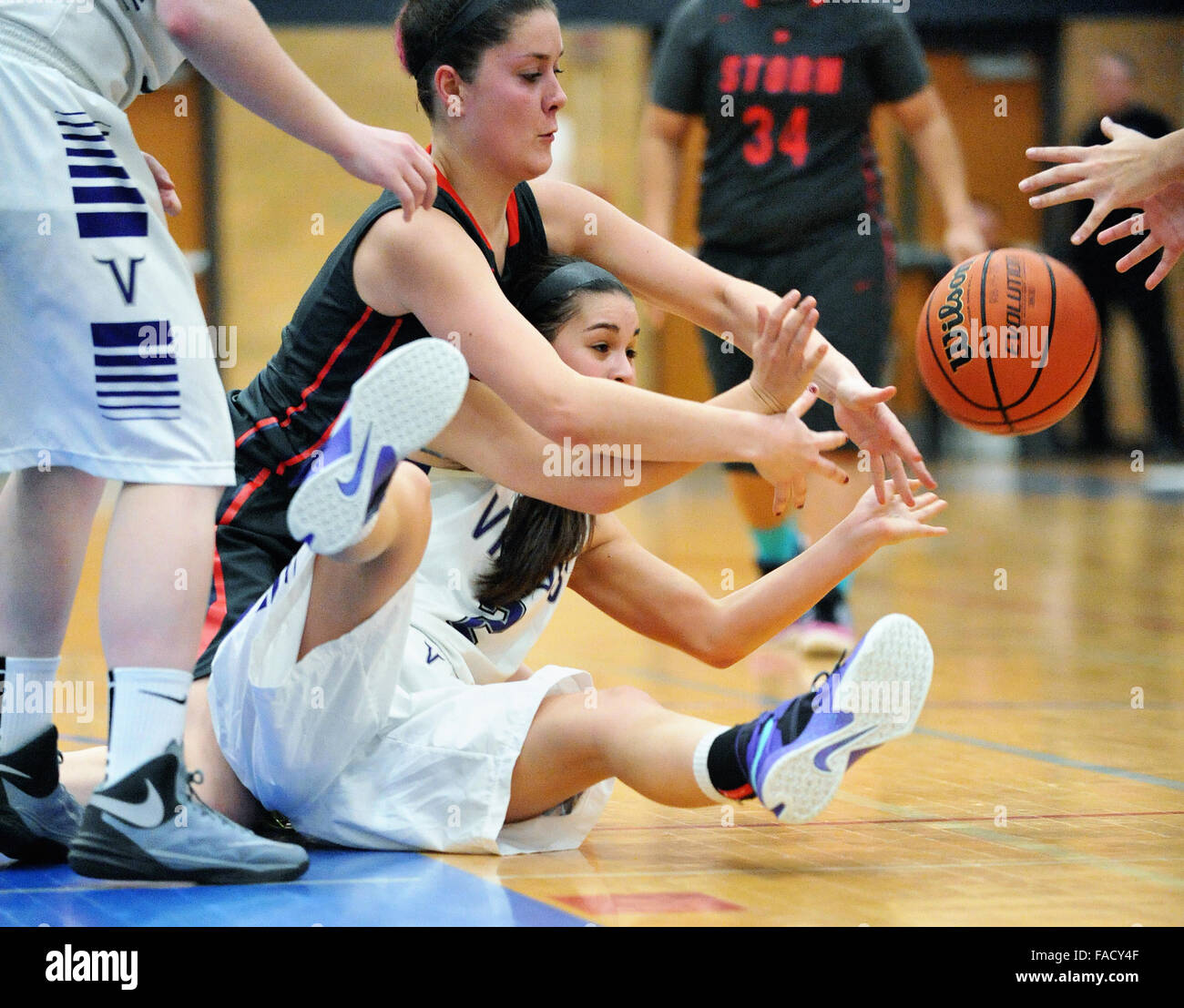 Players battle for possession of loose ball during a high school basketball game.USA. Stock Photo