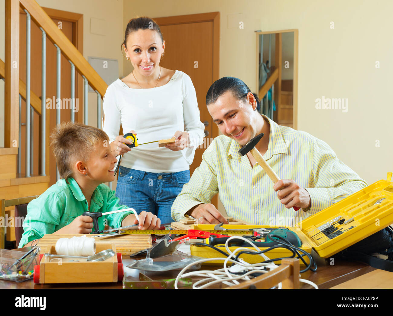 Happy family doing something with the working tools Stock Photo