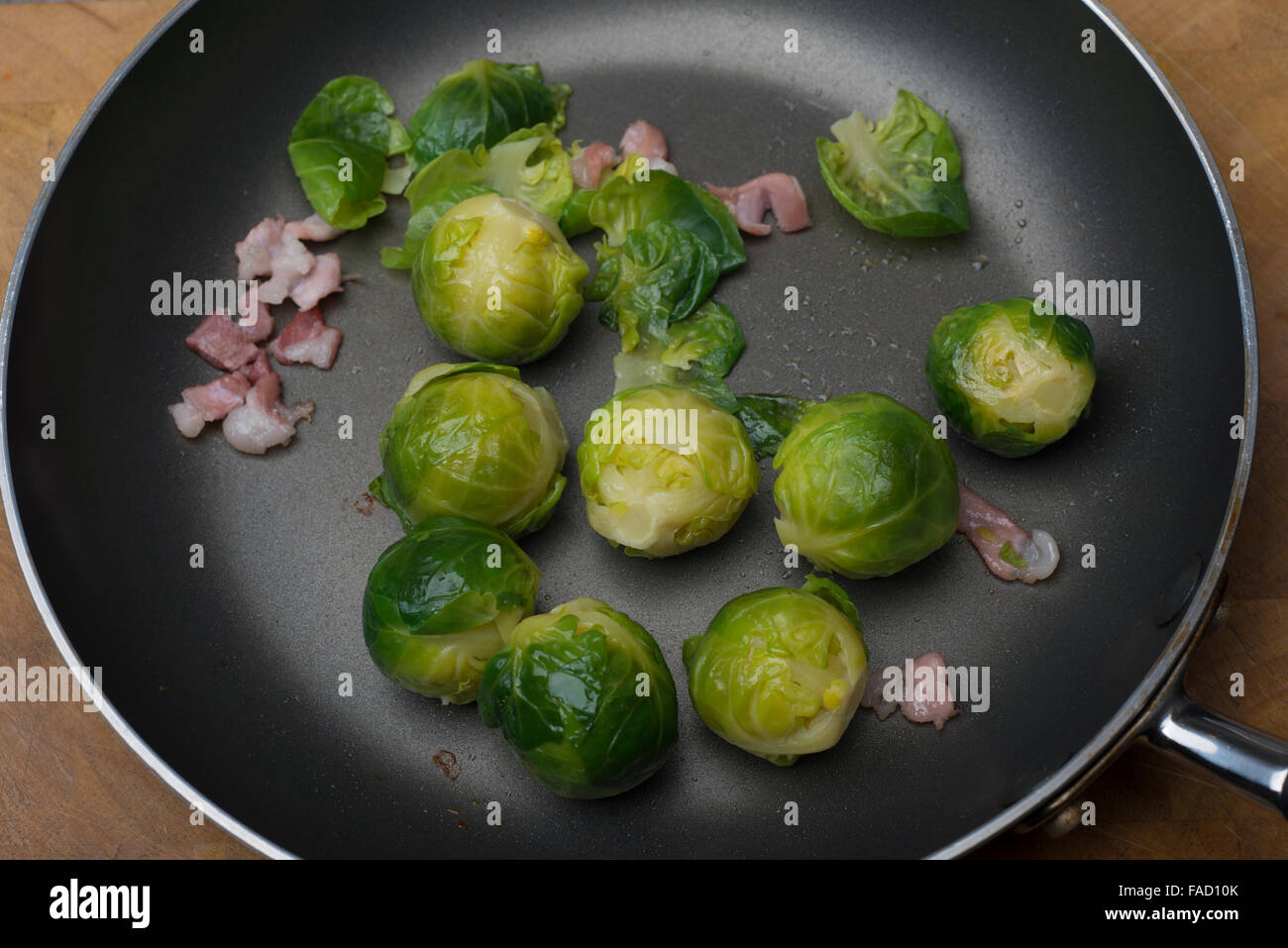 brussel sprouts and bacon in a frying pan Stock Photo